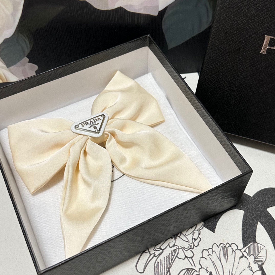 PRADA BOW-KNOT HAIR CLIP IN EGG SHELL SILK 358294