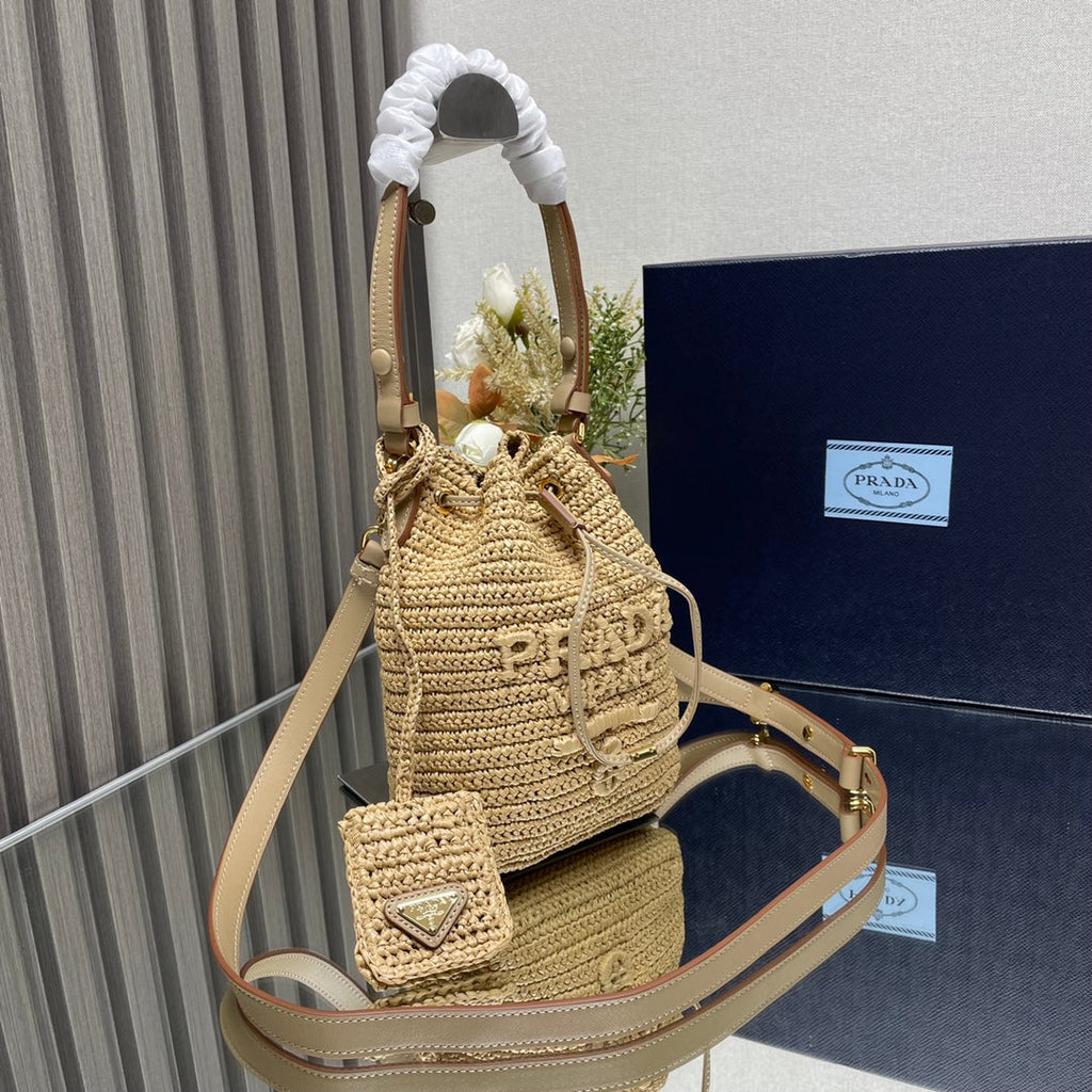 PRADA BUCKET BAG 20 IN BEIGE WOVEN RAFFIA EMBOSSED LOGO