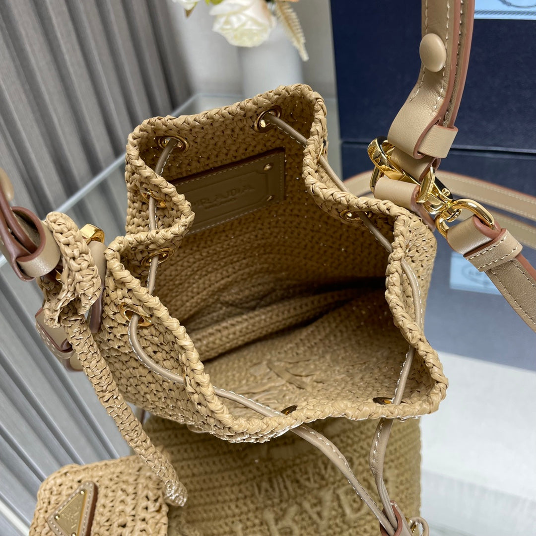 PRADA BUCKET BAG 20 IN BEIGE WOVEN RAFFIA EMBOSSED LOGO