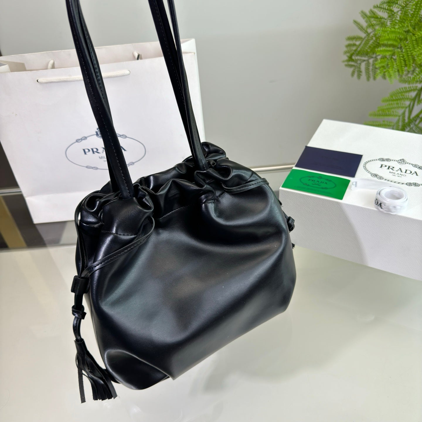 PRADA DRAWSTRING BUCKET BAG 25 IN BLACK SOFT LAMBSKIN